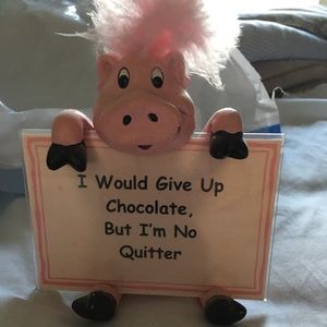 Pink Pig holding sign.
